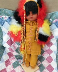17" VINYL FACE, PLASTIC BODY,  ABORIGINAL DOLL, BUCKSKINS, FEATHERS, WOOD STAND